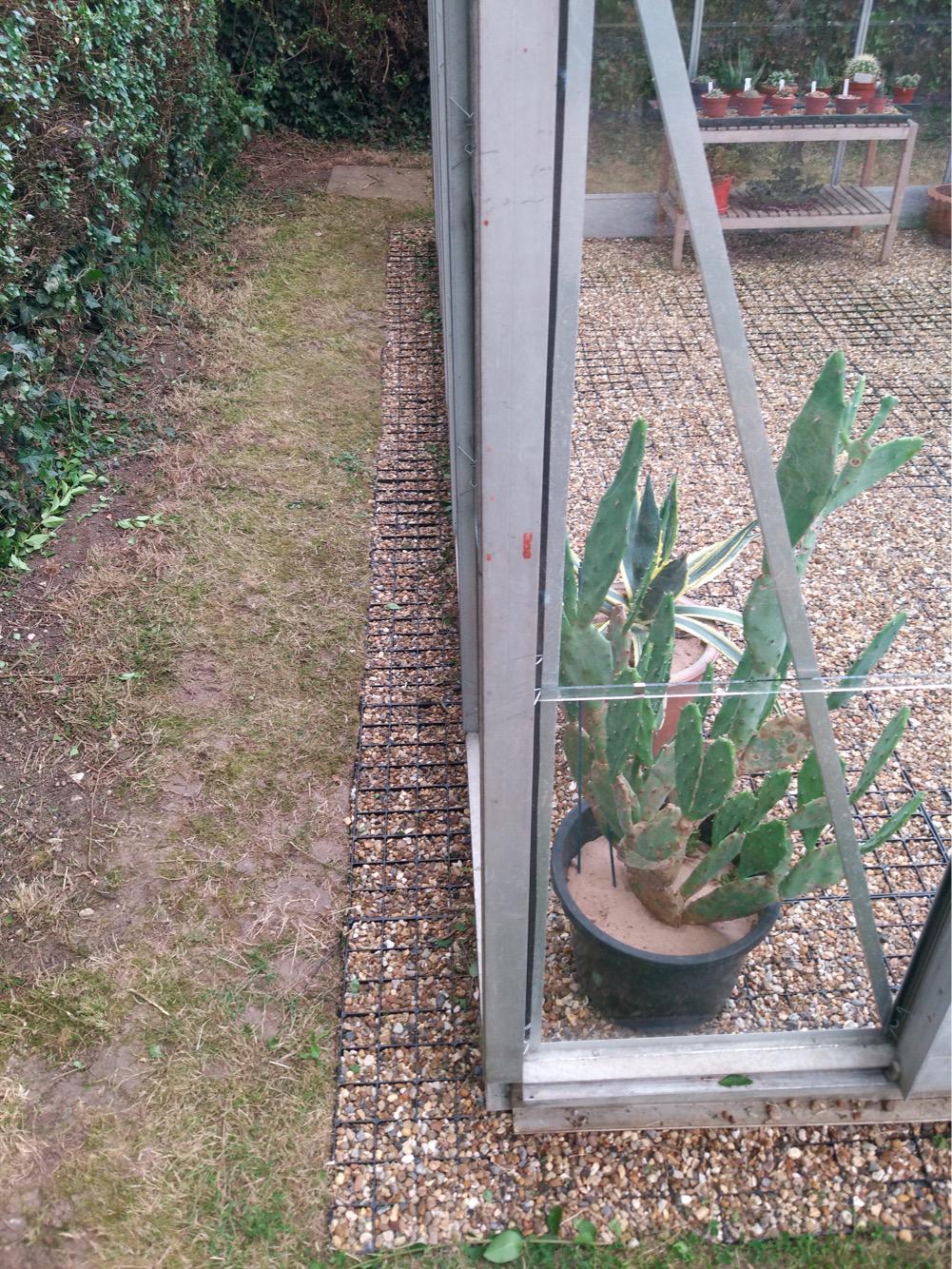 Plastic greenhouse base grids with gravel fill